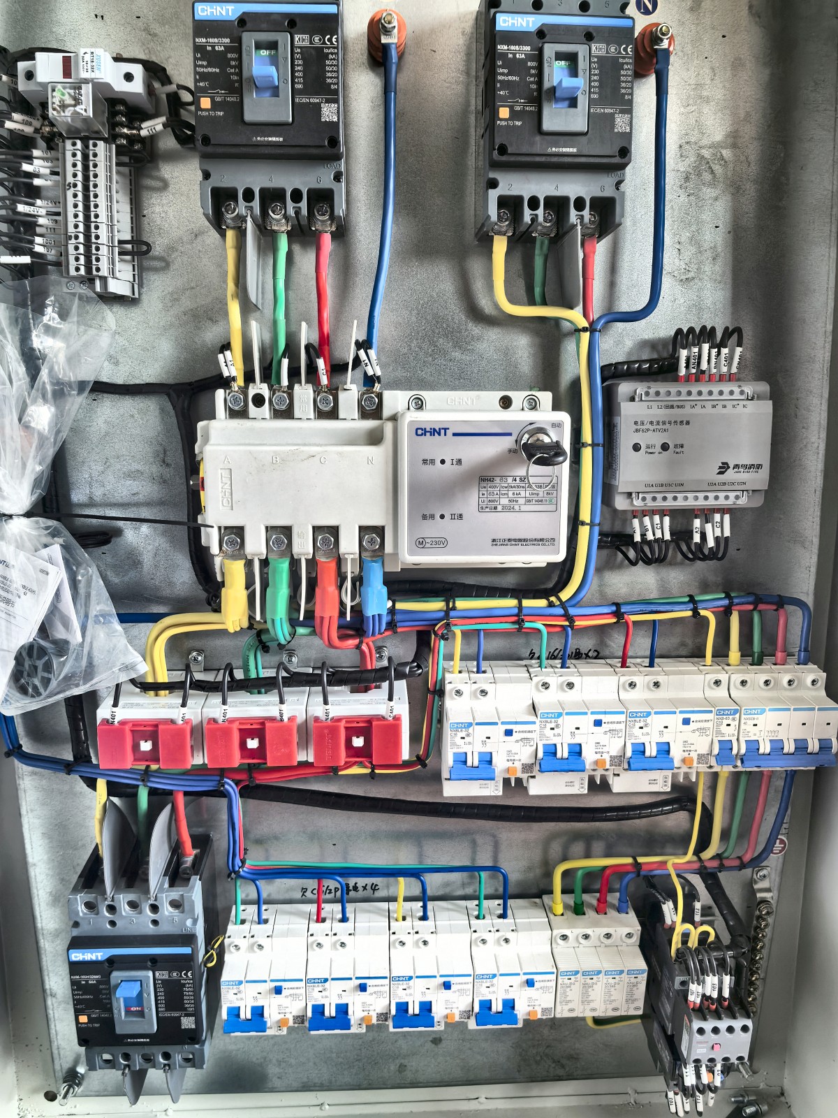 Electrical distribution cabinet with circuit breakers and phase colored wiring